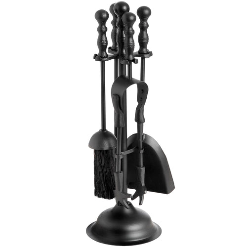 A black fireplace companion set including a brush, shovel, tongs, and a ladle, all standing in a black metal holder.