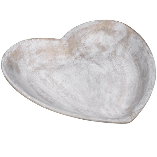 A heart-shaped, beige and brown natural stone dish.