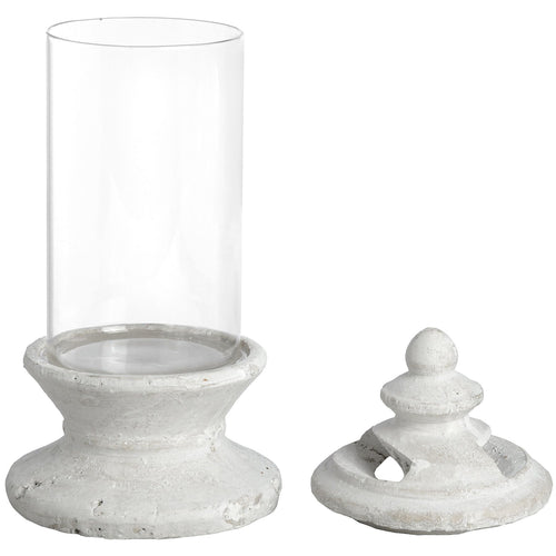 A white glass candle holder with a cylindrical shape and a decorative element on the lid, suitable for indoor use.