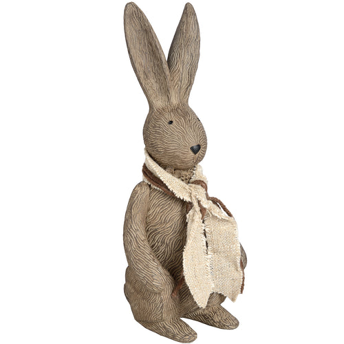 A small fabric rabbit with a beige scarf.