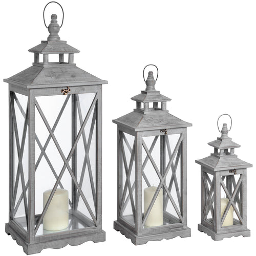 Set of three wooden lanterns with a cross-section design, featuring a natural wood grain and a distressed finish in gray color. Each lantern contains a candle, providing a warm glow.