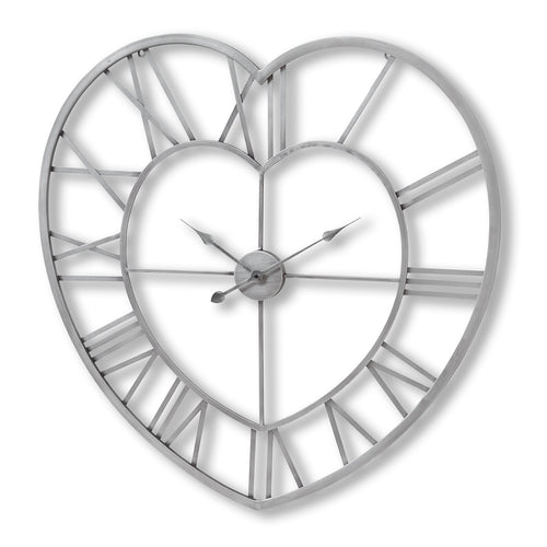 A wall clock with a heart-shaped frame, featuring a silver metal frame with roman numeral dials and hands.