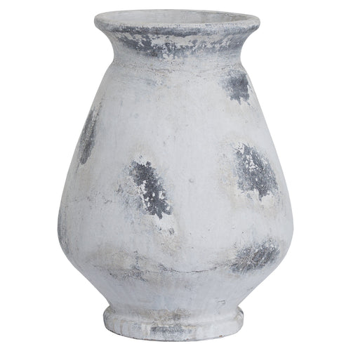 A large antique white vase with a Greek style design, displaying a weathered appearance with gray spots.