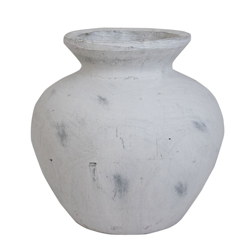 A large antique white vase with a Greek style inspiration.