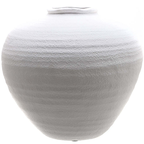A matte white ceramic vase with a sculptural silhouette, featuring a textured surface.