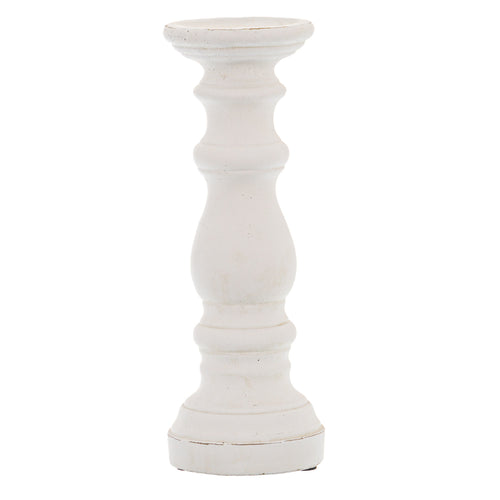 A matte white ceramic column candle holder with a cylindrical shape and a silver pinecone finial on top.