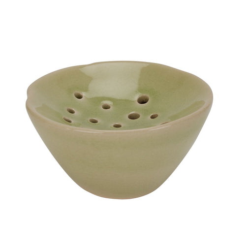 A light green ceramic flower frog with multiple holes on the bottom, displayed against a white background.