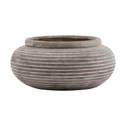 A brown round ribbed planter with horizontal ridges, with a wide top and a slightly narrower base, designed for indoor or outdoor use.