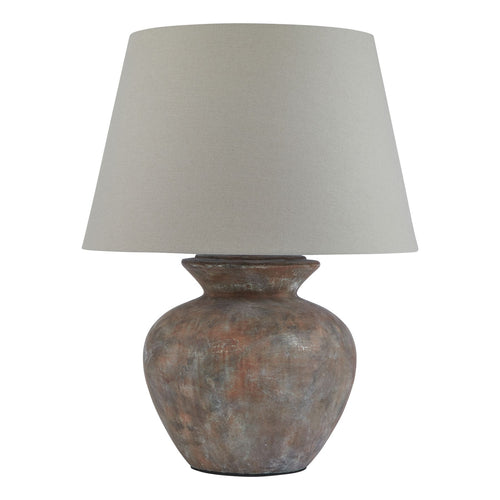 A round table lamp with a brown ceramic base and a beige linen shade.