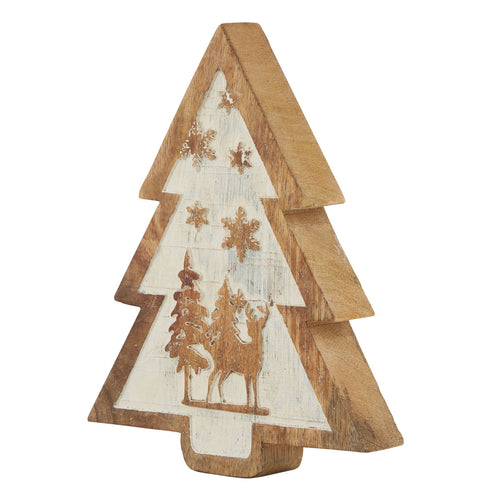 A rustic wooden tree decoration displaying a snow-covered winter forest scene with carvings of trees and stars, predominantly in beige and brown colors.