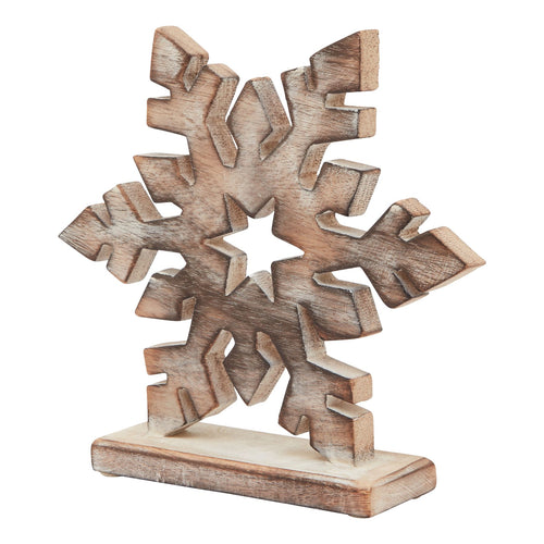 A laser-cut wooden snowflake decoration with a whitewash finish on a stand.