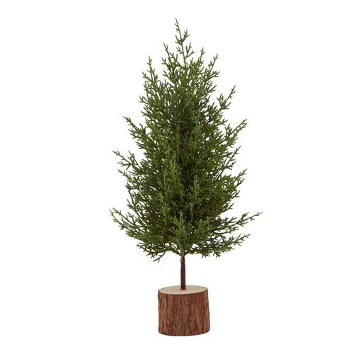 A small artificial green fir tree placed on a wooden log base.