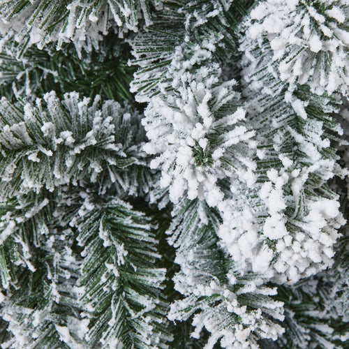 Close-up of a snowy artificial Christmas tree