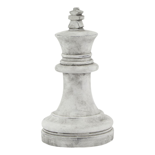 A white stone king chess piece with intricate detailing.
