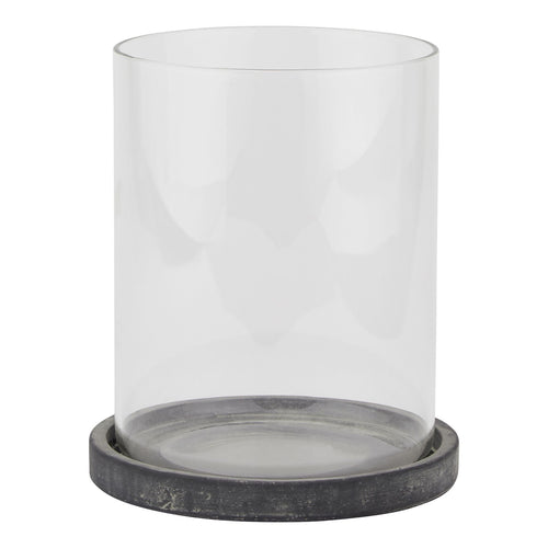 A grey hurricane lantern with clear glass panels and a distressed metal base.