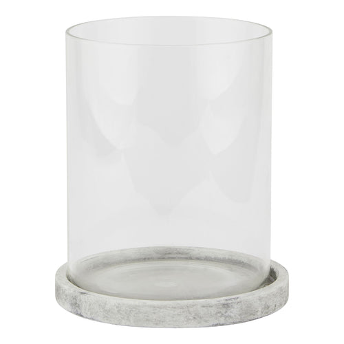 A large hurricane lantern with a stone-inspired finish base and clear glass upper part.