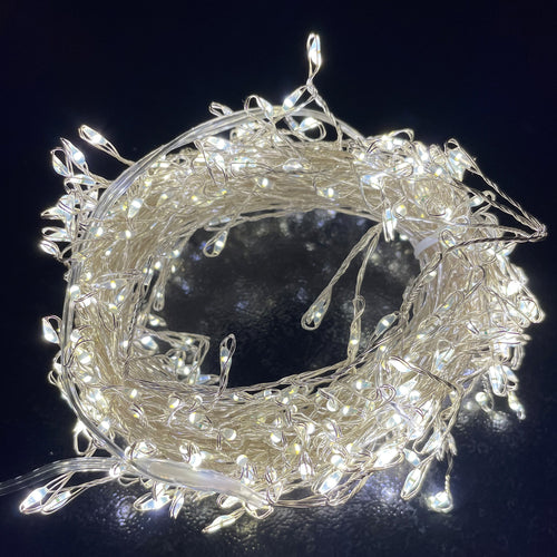 A coil of silver wire LED micro lights with a warm white glow.