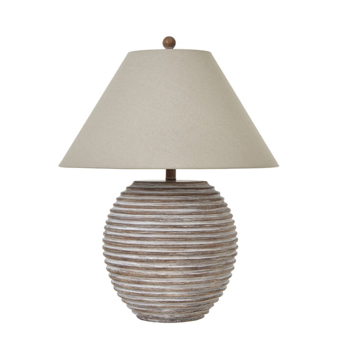 A Saturn table lamp with a linen shade, displaying a chic modern base with horizontal ridges, finished with a beige lampshade.