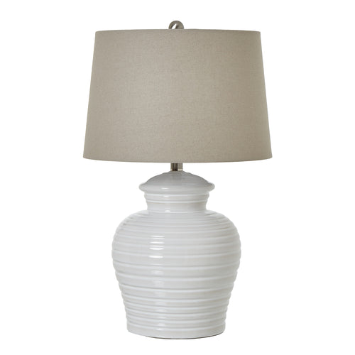 A white ceramic pot lamp with a linen shade, featuring horizontal ribbing on the base and a neutral color palette.
