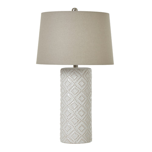 A white beaded ceramic lamp base with a linen shade, displaying a geometric pattern
