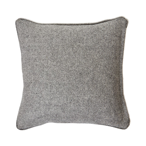 A square-shaped grey wool cushion with a herringbone pattern and piped edge.