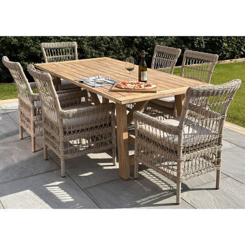 A large rectangular outdoor dining table made of acacia wood, accompanied by matching chairs with a woven design. The set is placed on an outdoor patio.