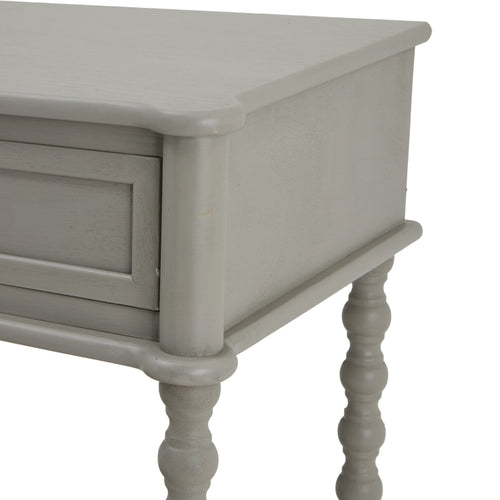 Corner of a gray console table with two drawers and a lower shelf, featuring a sleek design with spindle legs.
