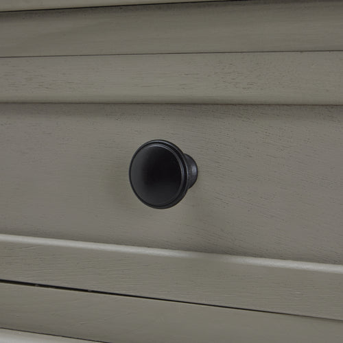 Drawer handle close up of a  gray console table with two drawers and a lower shelf, featuring a sleek design with spindle legs.