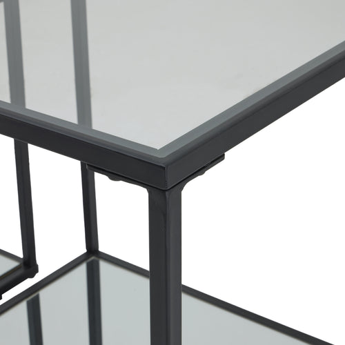 Top Corner of a  set of two contemporary black framed side tables with glass tops and metal legs, part of the Lennox collection. 