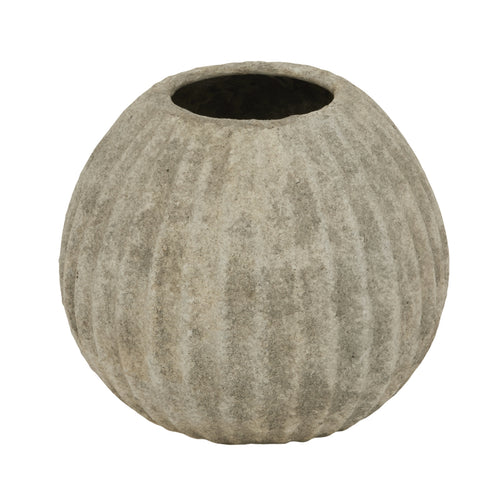 A beige round ceramic vase with a textured surface.