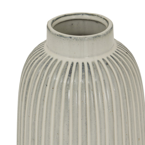 Top of a white, bell-shaped, ceramic Monte vase with vertical ridges, displayed against a plain background.