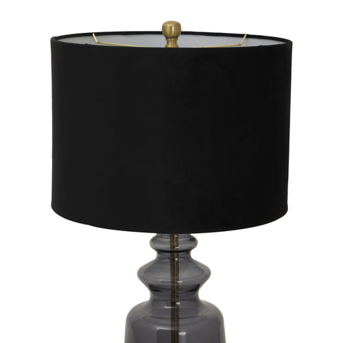 The top of a Luxton glass urn lamp with a black velvet shade and gold accents on the finial and base.