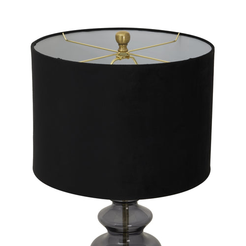 A top view of a Luxton glass urn lamp with a black velvet shade and gold accents on the finial and base.