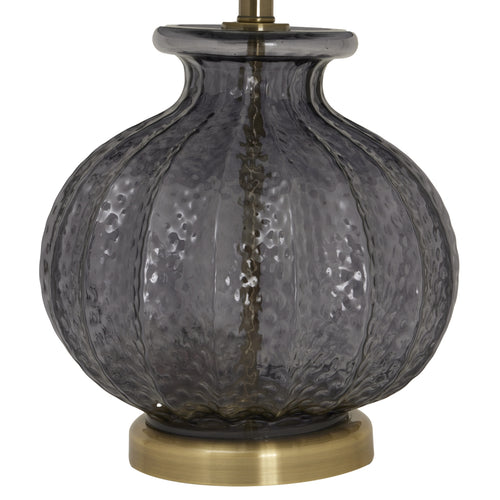 The bottom of a Luxton glass fluted lamp with a black velvet shade and a gold base, part of the Luxton collection.