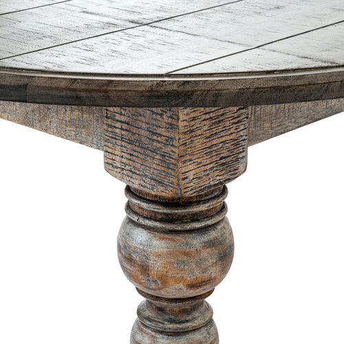 Close-up of a wooden table with a detailed leg on a white background