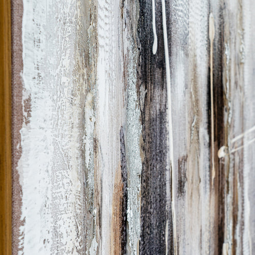Close-up of a textured wall with horizontal stripes in various colors.