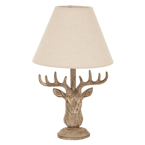 Decorative table lamp with deer head design and beige lampshade on a white background