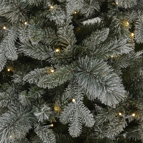 Close-up of a frosted artificial Christmas tree with lights.