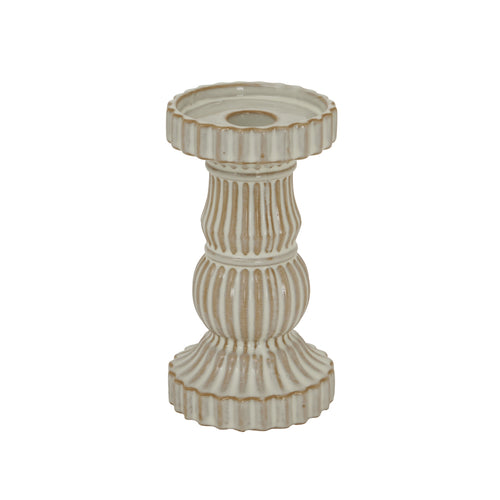 Decorative candle holder with ribbed design on a white background