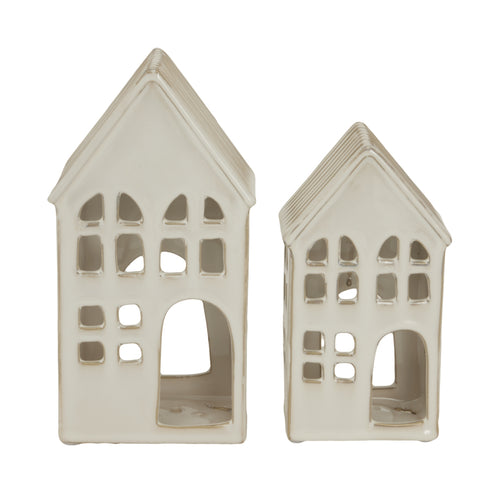Two white ceramic house-shaped lanterns on a white background