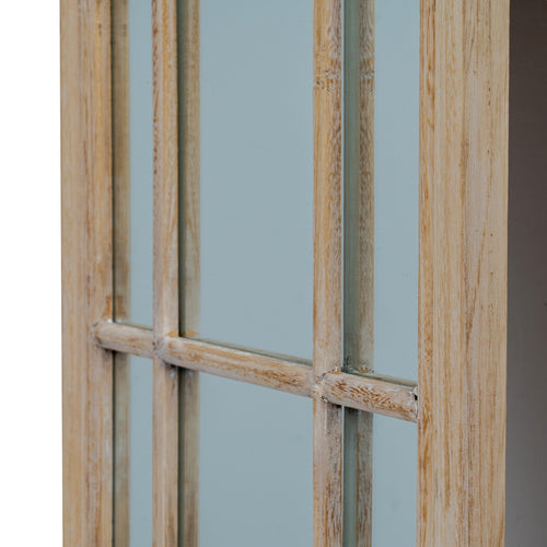 Wooden window frame with glass panes against a light blue wall