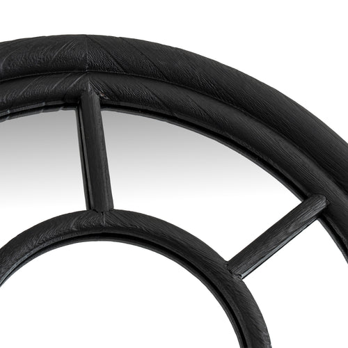 Close-up of a black metal wheel with spokes on a white background
