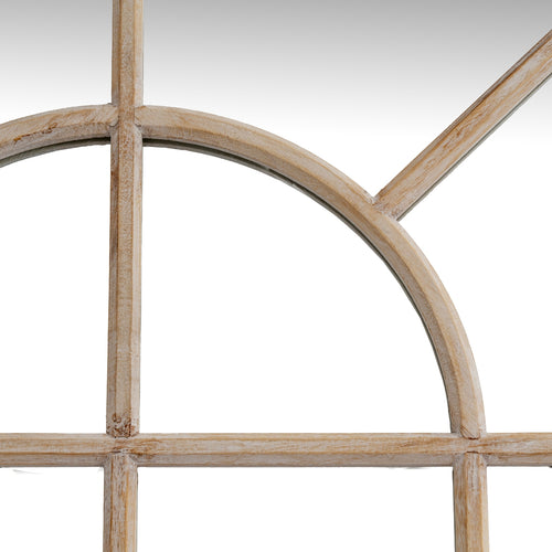 Close-up of a wooden window frame with a round arch on a white background