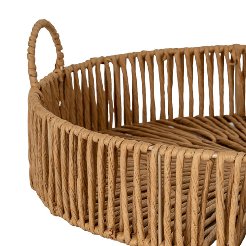 Close up of Woven brown basket with handles on a white background