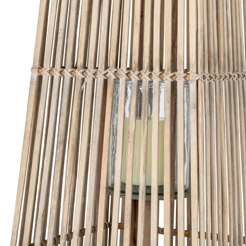 Close up of Wicker basket with a glass container inside on a white background