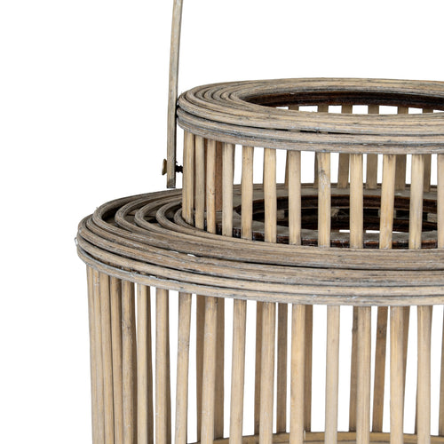 Close up of Woven rattan basket with a handle on a white background