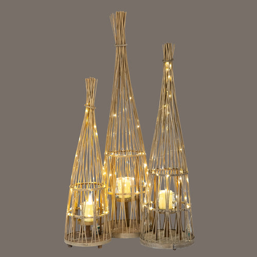 Three woven candle holders with string lights on a gray background
