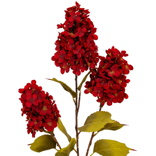 Artificial red flower branch with green leaves on a white background