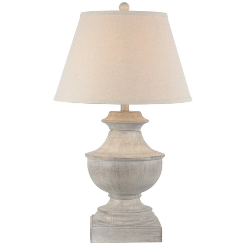 Table lamp with a beige shade and textured base on a white background