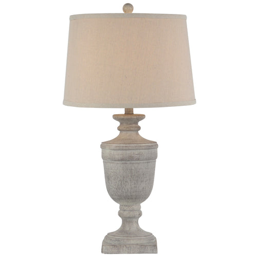 Table lamp with a textured base and beige lampshade on a white background